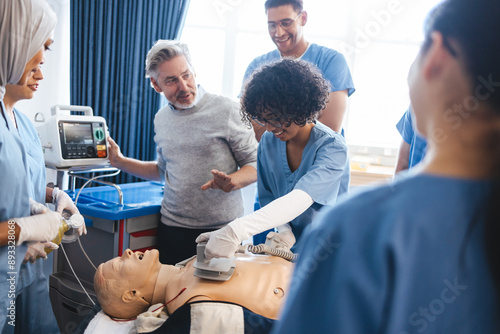 Medical training: Health professional teaches students resuscitation with a defibrillator