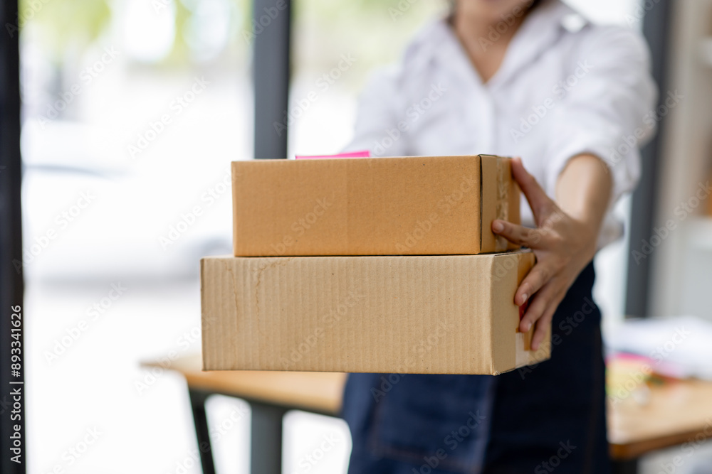 Startup small business entrepreneur or freelance Asian woman using a laptop with box, Young success Asian woman with her hand lift up, online marketing packaging box and delivery, SME concept.
Startup small business entrepreneur or freelance Asian woman using a laptop with box, Young success Asian woman with her hand lift up, online marketing packaging box and delivery, SME concept.