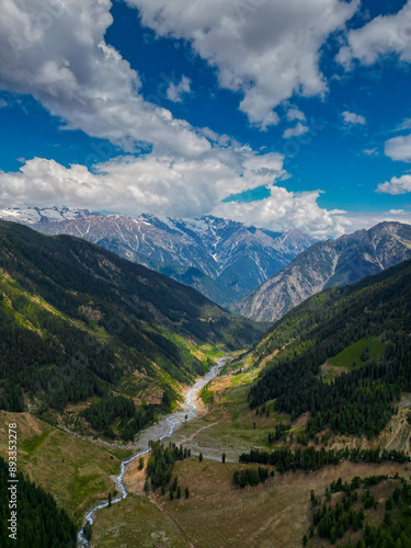 Flying over a very winding river and forest in Taip Meadows, Swat Valley, Pakistan