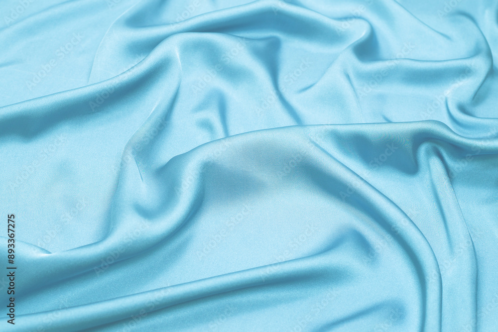 Obraz premium Blue silk or satin luxury fabric texture. Top view.