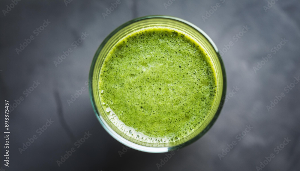 Green smoothie on gray stone table. Healthy and tasty beverage. Organic detox drink.
