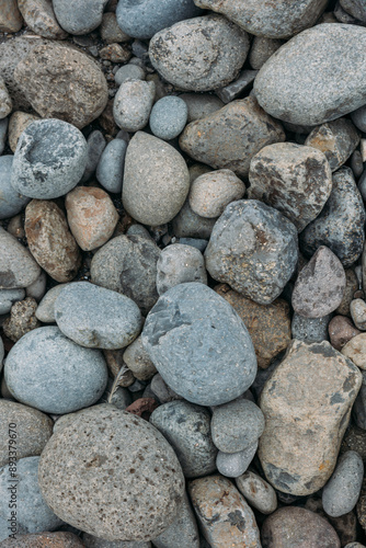 Abstract smooth round pebbles sea texture background. Stones in Faroe island