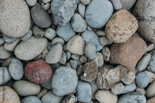 Abstract smooth round pebbles sea texture background. Stones in Faroe island