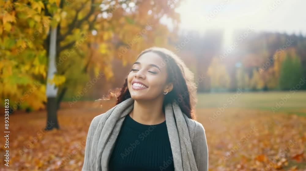 Happy smiling young Woman enjoying in autumn sunny day among tree leaves in the park. African American female in fall nature on sunny day 4k video Happy smiling young Woman enjoying in autumn sunny day among tree leaves in the park. African American female in fall nature on sunny day 4k video