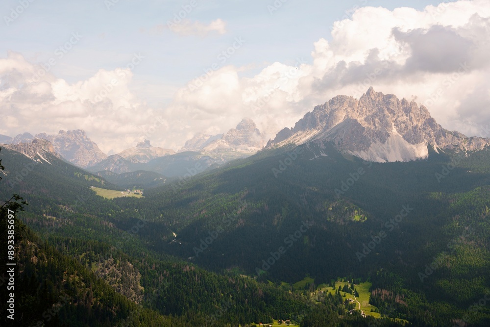 Fototapeta premium Landscapes of epic mountains during the sunset surrounded by clouds, with warm and cold lights. huge cliffs and epic views from the wild nature. 