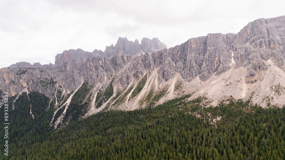 Fototapeta premium Landscapes of epic mountains during the sunset surrounded by clouds, with warm and cold lights. huge cliffs and epic views from the wild nature. 
