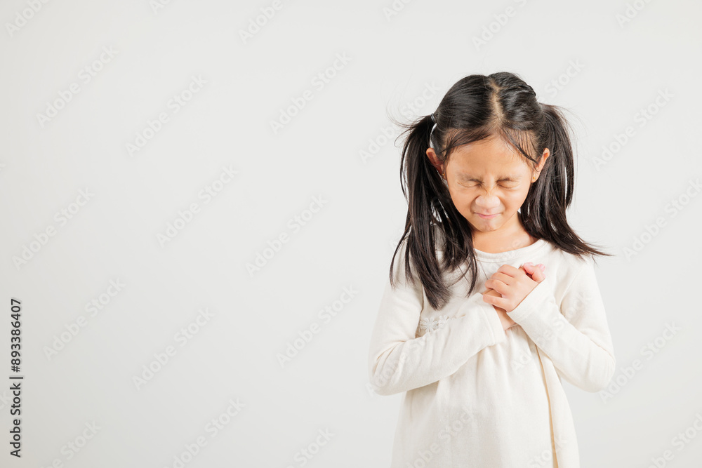 Young kid girl pressing on chest pain isolated on white background, painful expression heartache, kindergarten children having heart attack heart disease, Painful cramps problem Young kid girl pressing on chest pain isolated on white background, painful expression heartache, kindergarten children having heart attack heart disease, Painful cramps problem