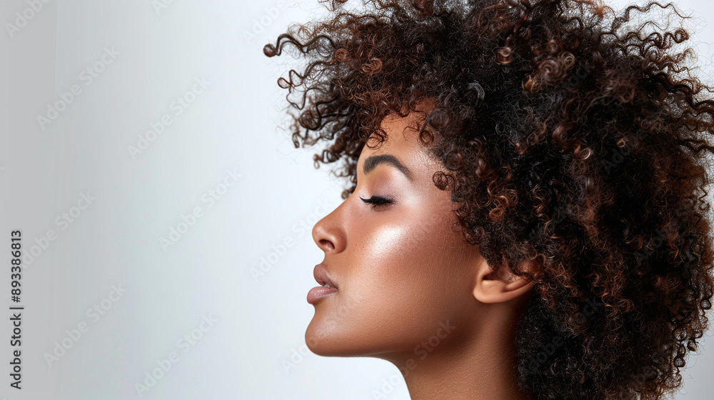 Side view of young woman model with curly hair on white background Side view of young woman model with curly hair on white background