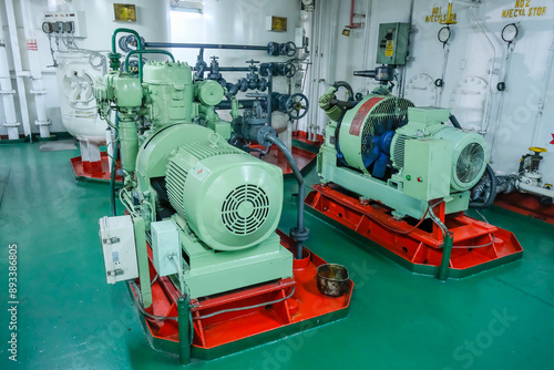 Air compressors inside engine room of cargo ship