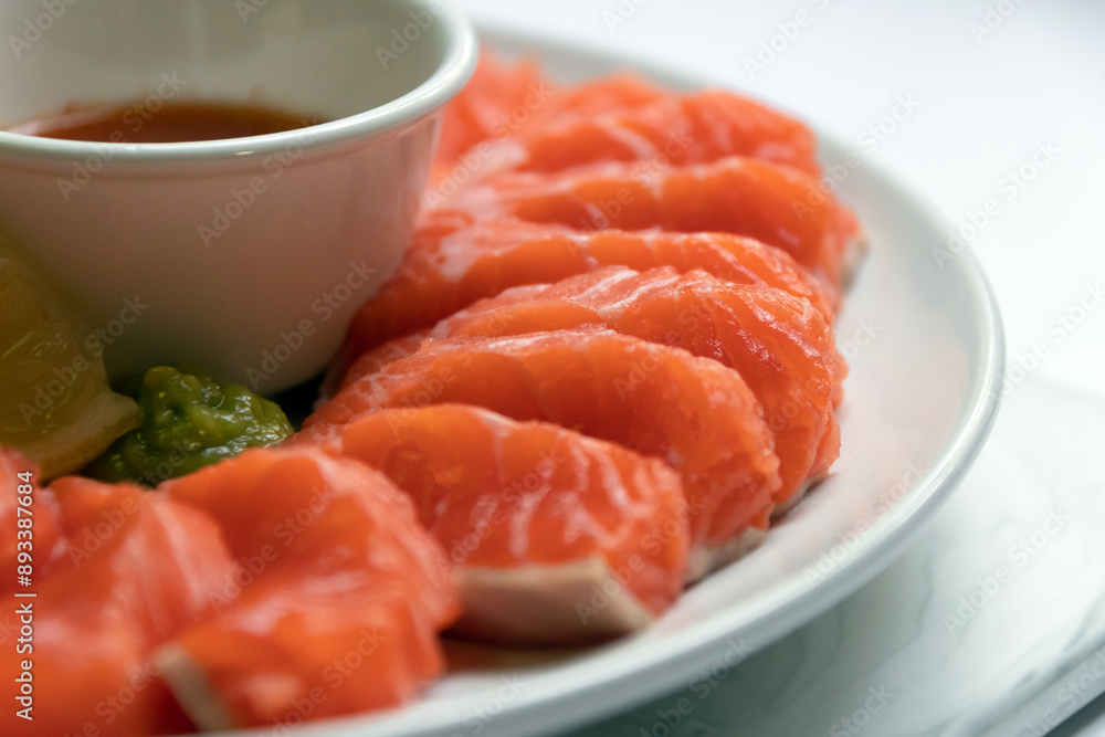 Fresh salmon sashimi serve on plate with spicy sauce. Japanese food style. Fresh salmon sashimi serve on plate with spicy sauce. Japanese food style.