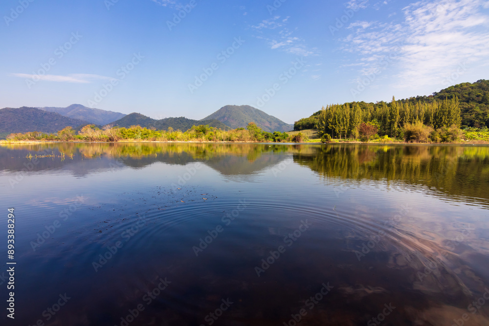 Beautiful landscape with reflection of mountain range on water at Tha Khoei reservoir in Ratchaburi, Thailand. Beautiful landscape with reflection of mountain range on water at Tha Khoei reservoir in Ratchaburi, Thailand.