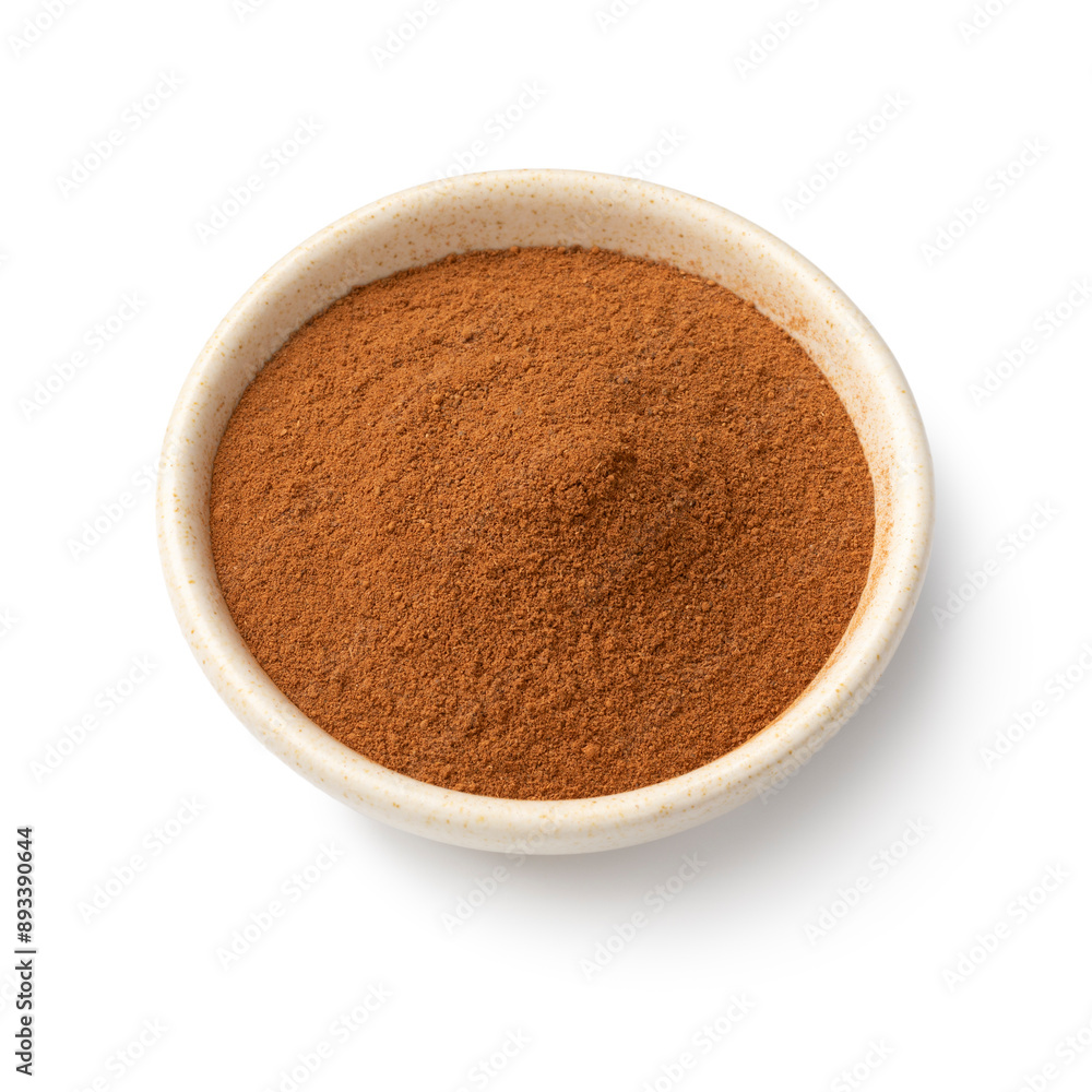 Bowl with ground cinnamon close up isolated on white background Bowl with ground cinnamon close up isolated on white background