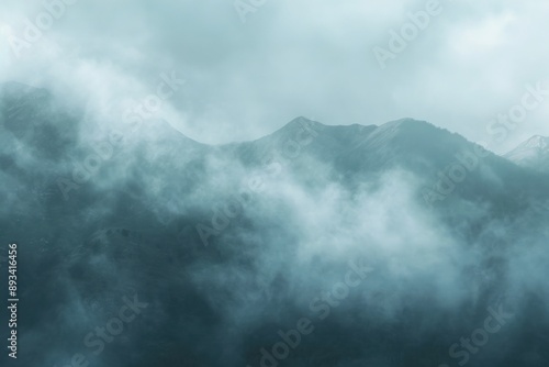 Rocky mountain peaks emerge through the misty clouds. fog