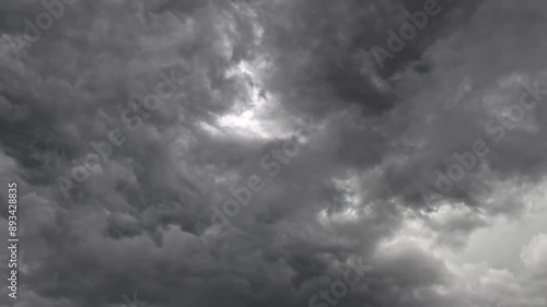 Dark clouds gather in a stormy sky on a summer day, brewing an ominous atmosphere that portends the coming tempest