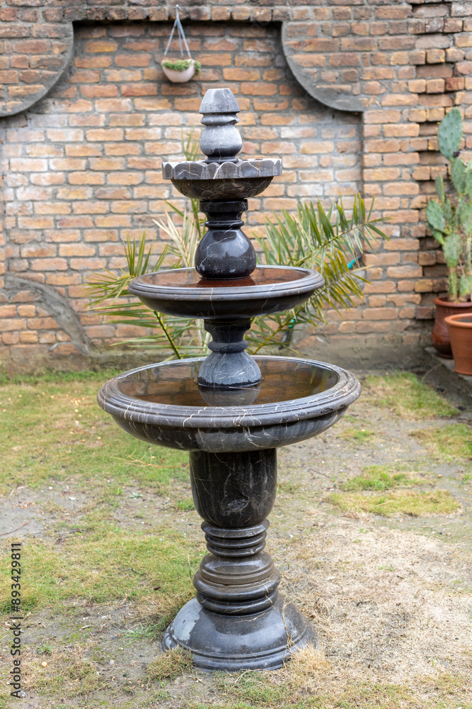 Elegant Three-Tiered Marble Fountain in Garden Elegant Three-Tiered Marble Fountain in Garden