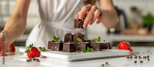 A woman garnishes chocolate...