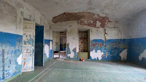 Classroom in an abandoned school, with peeling paint and crumbling wall and ceiling. Hunting at a forgotten past. Halloween or horror interior
