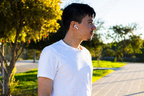 man in the park or green area looking towards the horizon, with a fixed and relaxed expression