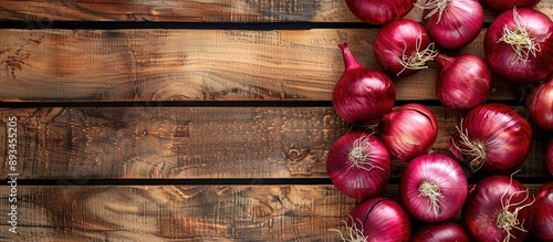 Red Onions on a bright wood...