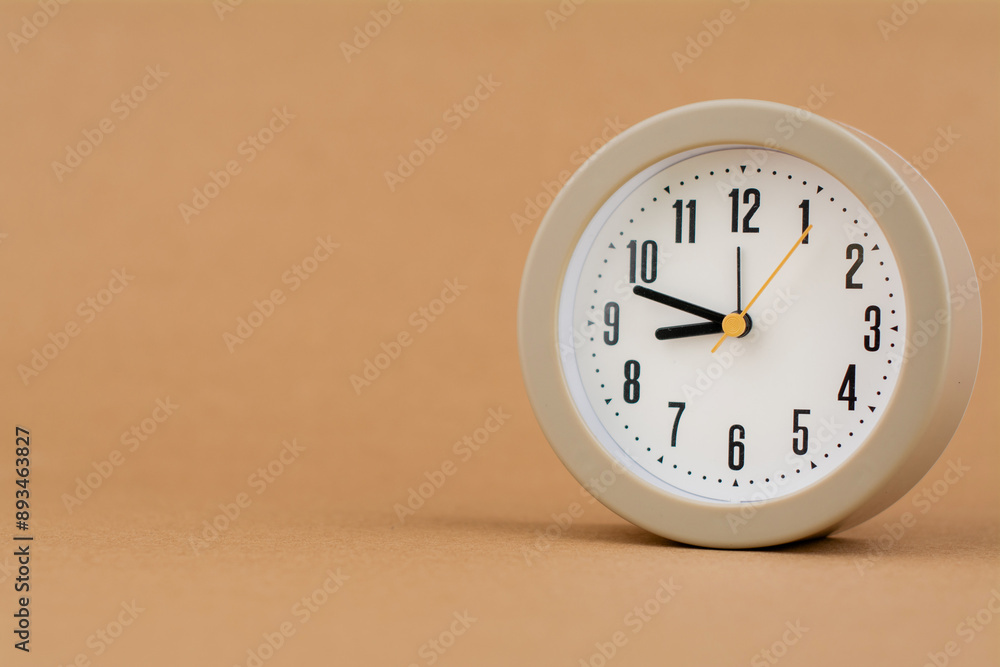 Alarm clock photography in a light brown background studio The concept of time and living and working Alarm clock photography in a light brown background studio The concept of time and living and working