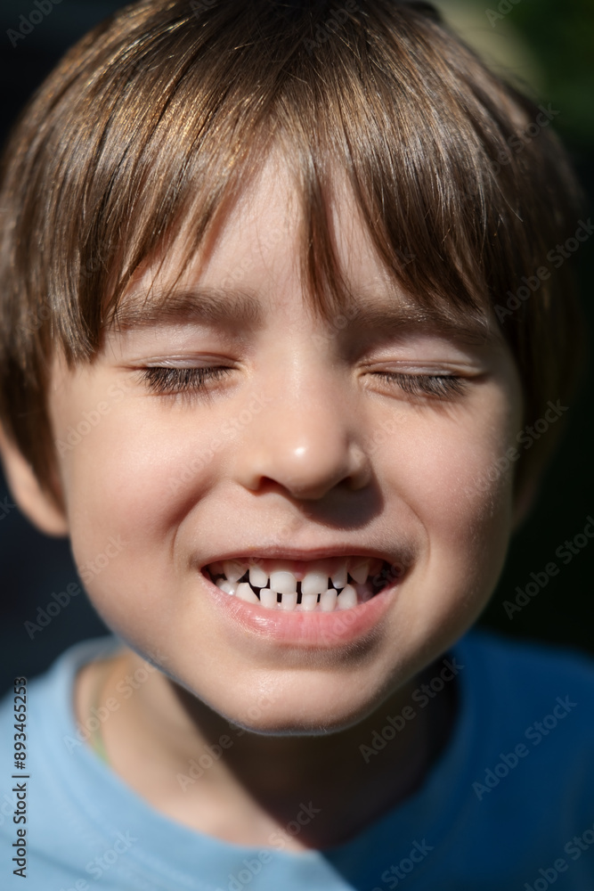 Close-up headshot of little preschool cute boy widely smiling, showing the first baby milk teeth. Happy four or five years old small adorable cutie toddler with primary teeth. Portrait Close-up headshot of little preschool cute boy widely smiling, showing the first baby milk teeth. Happy four or five years old small adorable cutie toddler with primary teeth. Portrait