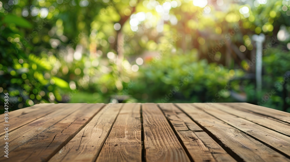 Wooden table surface with blurred garden view for product display or design layout Wooden table surface with blurred garden view for product display or design layout