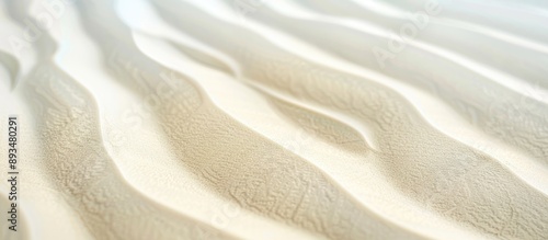 Close up of a textured white sandy beach with a wavy pattern natural grains clean rippled surface light yellow dunes on a tropical sea backdrop with copy space image