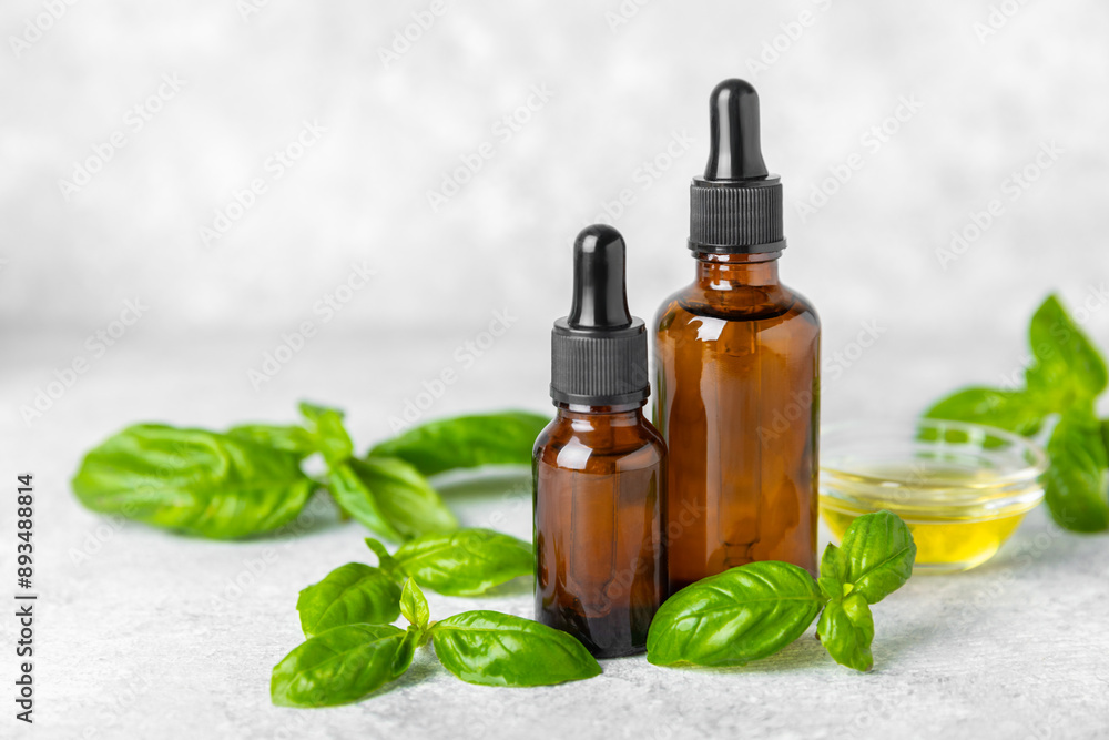 Basil essential oil on a textured wooden background. Basil essential oil and fresh leaves. Aromatherapy. Aroma oil. Medical herbs. Alternative medicine. Place for text. Copy space. Basil essential oil on a textured wooden background. Basil essential oil and fresh leaves. Aromatherapy. Aroma oil. Medical herbs. Alternative medicine. Place for text. Copy space.