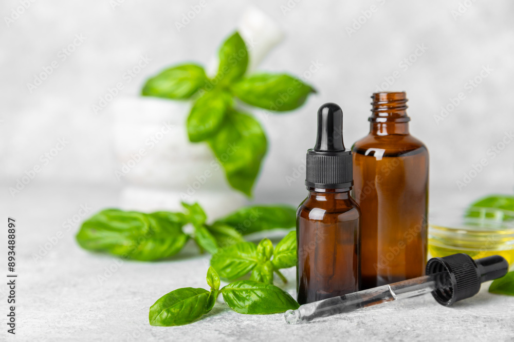 Basil essential oil on a textured wooden background. Basil essential oil and fresh leaves. Aromatherapy. Aroma oil. Medical herbs. Alternative medicine. Place for text. Copy space. Basil essential oil on a textured wooden background. Basil essential oil and fresh leaves. Aromatherapy. Aroma oil. Medical herbs. Alternative medicine. Place for text. Copy space.