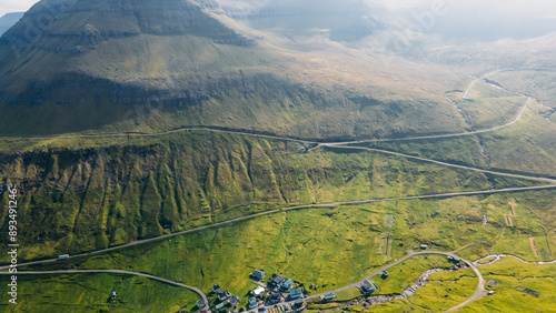 Funningur village, Faroe Islands. Sunny day in summer. Amazing nature in Faroe Islands. Eysturoy Island. Gonguturur or Hvithamar Trailhead. Faroese fjord and summits