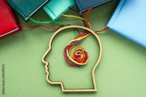 Fotografija Upskill or lifelong learning. Head, books and threads.