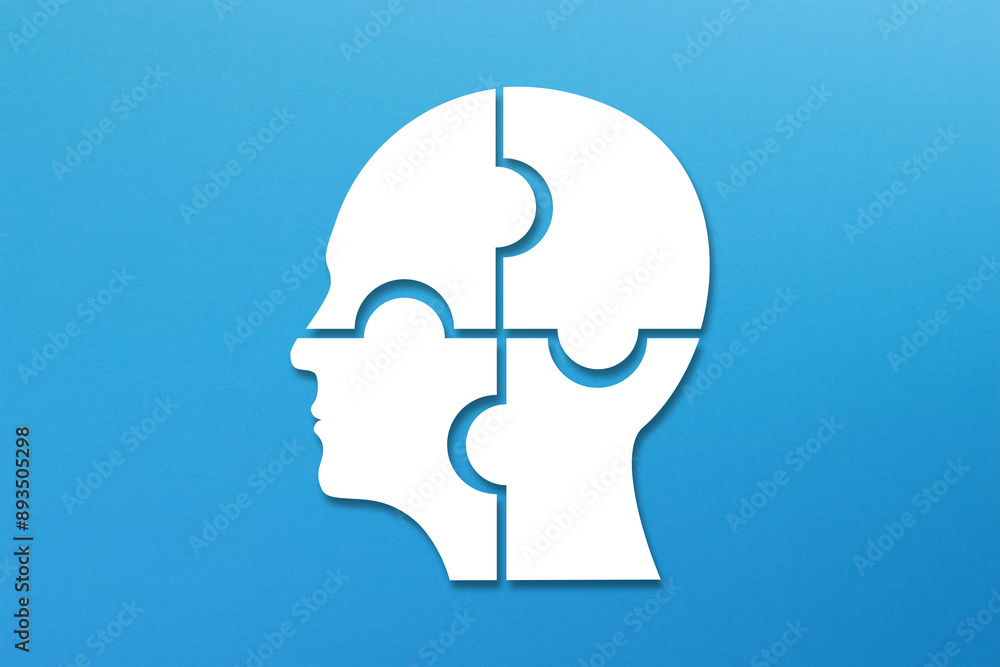 Head made of white jigsaw puzzle four pieces on blue background
