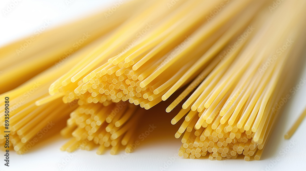 Bundles of uncooked spaghetti neatly arranged, showcasing the long, thin pasta strands, set against a white background, emphasizing their texture and uniformity. Bundles of uncooked spaghetti neatly arranged, showcasing the long, thin pasta strands, set against a white background, emphasizing their texture and uniformity.