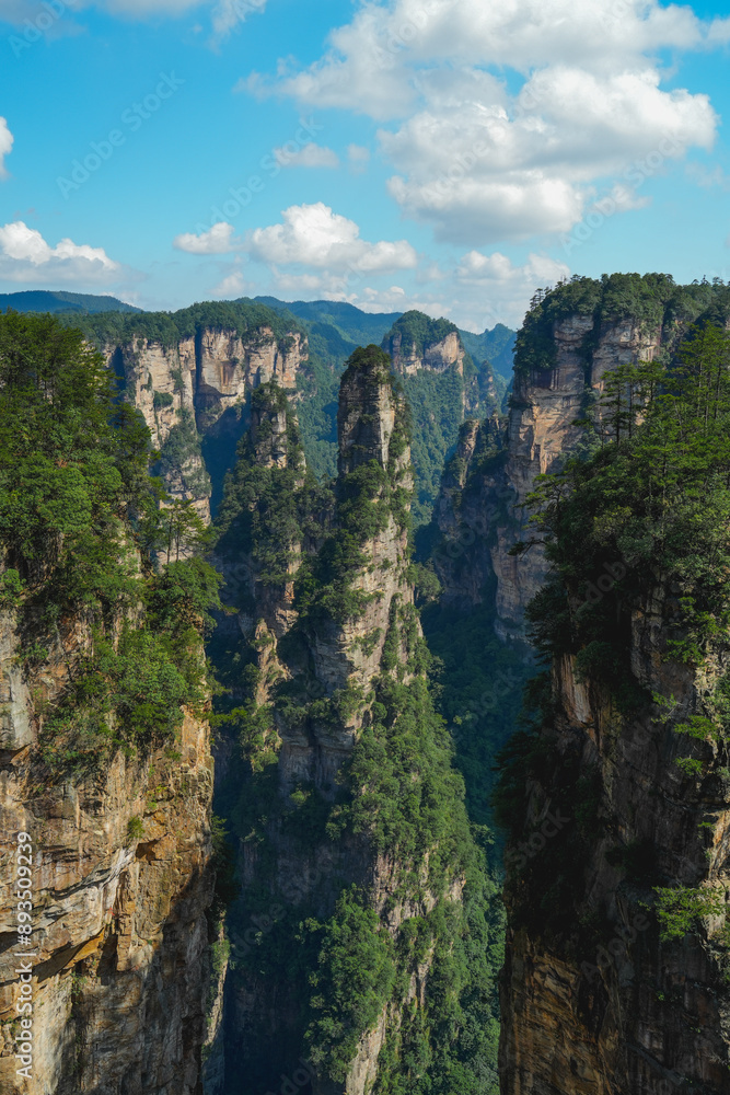 Fototapeta premium Zhangjiajie national forest park, China, Glass bridge of Zhangjiajie China Tianzishan with blue sky, concept of world heritage, avatar, heritage peak or cliff mountain, tourist attraction famous place