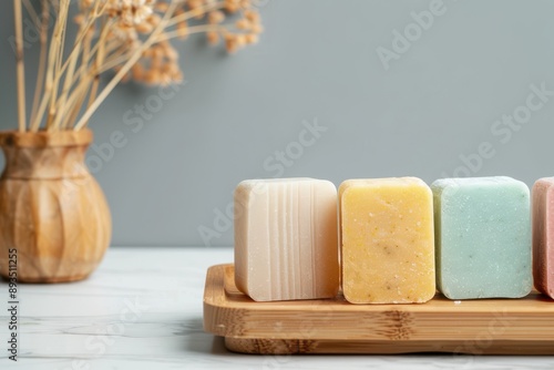 Colorful handmade soap bars on wooden tray with dried flowers in the background, perfect for spa or skincare visuals. photo