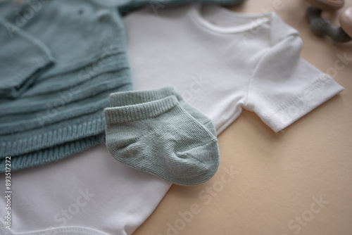 Cute green socks for newborn baby. Baby clothing and happy motherhood concept. 