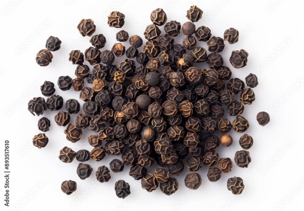 Black peppercorn pile and minced black pepper, white background, top view Black peppercorn pile and minced black pepper, white background, top view