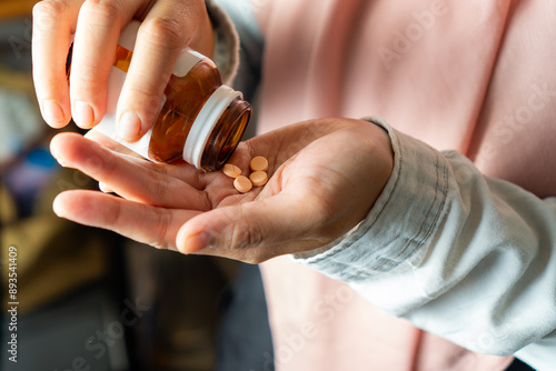 woman taking tablet of vitamin or supplement