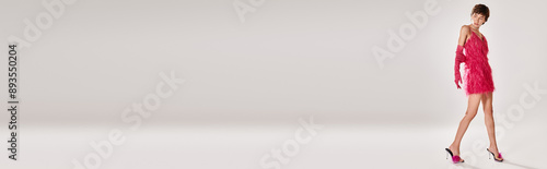 Wallpaper Mural Fashionable woman in pink dress and high heels posing on vibrant backdrop. Torontodigital.ca