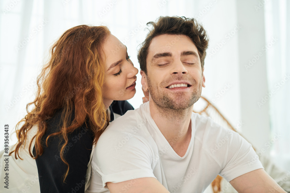 A man and a woman relax on a couch together, enjoying each others company in a cozy setting. A man and a woman relax on a couch together, enjoying each others company in a cozy setting.