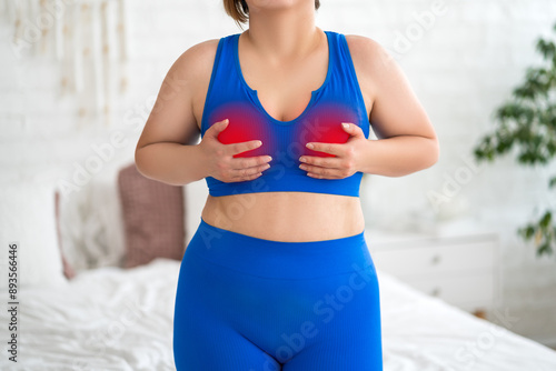 Breast test, woman in blue bra examining her breasts for cancer at home, mastitis ore mastopathy disease