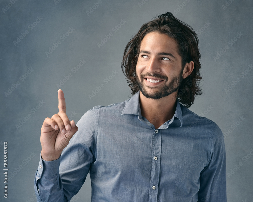 Studio, thinking and business man with pointing for announcement, promotion and smile with pride. Professional career, sales assistant and hand gesture for marketing deal, choice and gray background Studio, thinking and business man with pointing for announcement, promotion and smile with pride. Professional career, sales assistant and hand gesture for marketing deal, choice and gray background