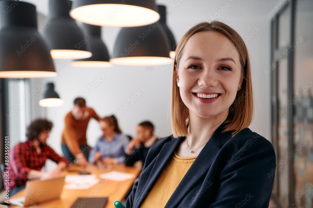 Confident Blonde Businesswoman Leading Team in Modern Office Setting. Confident Blonde Businesswoman Leading Team in Modern Office Setting.