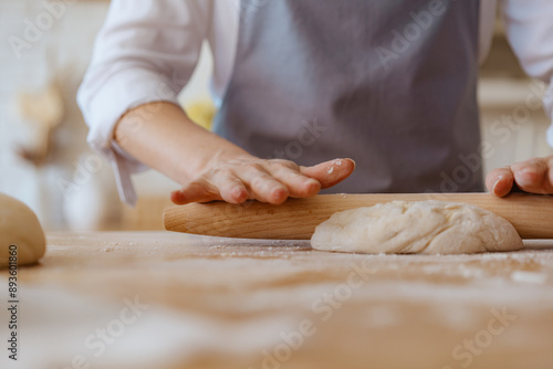 Obraz na płótnie woman's hands kneading dough on the kitchen table