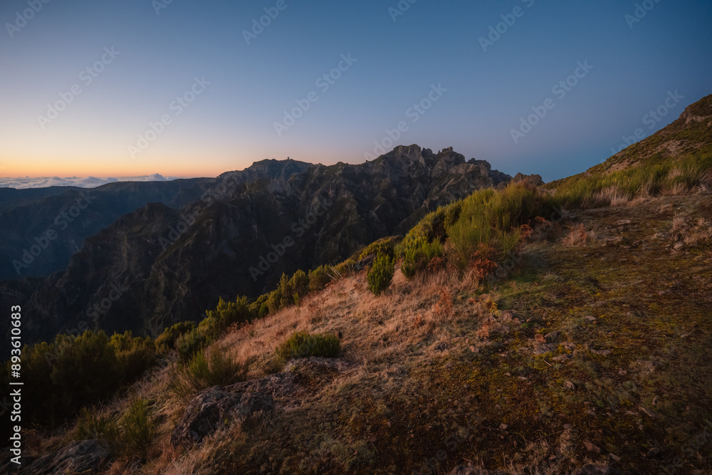 Hiking on the highest peak of Madeira Pico Ruivo next to the cottage Abrigo do Pico Ruivo. Views of the surrounding mountains lanscape during sunrise Hiking on the highest peak of Madeira Pico Ruivo next to the cottage Abrigo do Pico Ruivo. Views of the surrounding mountains lanscape during sunrise
