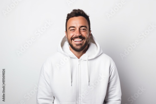 Portrait of a joyful man in his 30s wearing a zip-up fleece hoodie isolated on white background