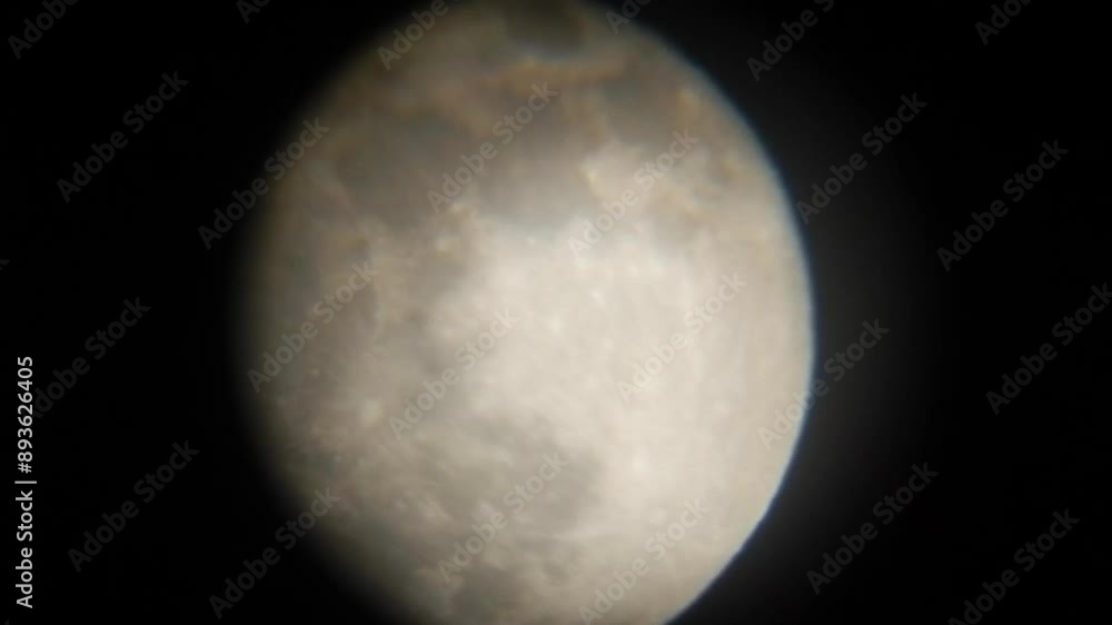 Slowly moving full moon in February called Snow Moon against and dark sky - image seen through telescope eyepiece. Topics: astronomy, space, satellite, observation, science, weather, atmosphere Slowly moving full moon in February called Snow Moon against and dark sky - image seen through telescope eyepiece. Topics: astronomy, space, satellite, observation, science, weather, atmosphere