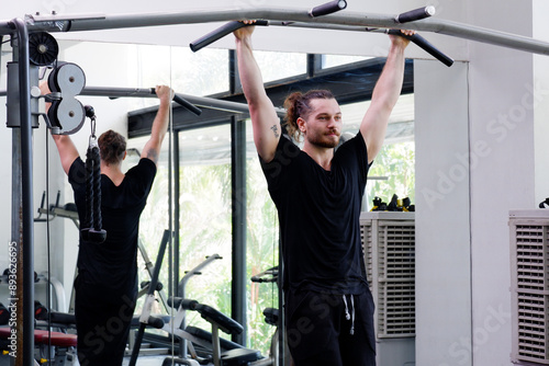 Young man exercising in the fitness center Exercise for health.