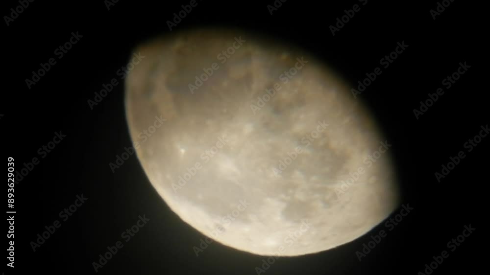 Slowly moving full moon in February called Snow Moon against and dark sky - image seen through telescope eyepiece. Topics: astronomy, space, satellite, observation, science, weather, atmosphere