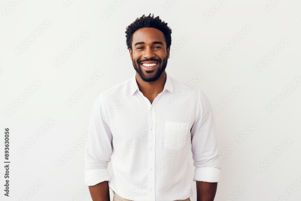 Portrait of a satisfied afro-american man in his 20s wearing a classic white shirt in white background Portrait of a satisfied afro-american man in his 20s wearing a classic white shirt in white background